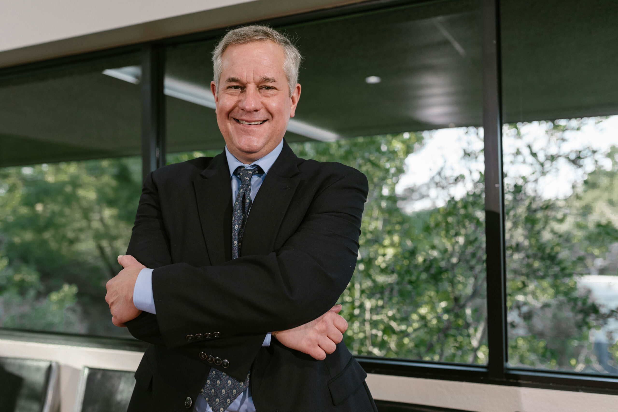 An experienced leader from the expert networks space smiles in a board room while discussing key private equity insights.