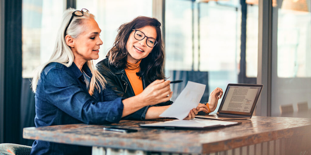 Two experts collaborate closely, reviewing a document and discussing key findings. Our team's expertise and attention to detail ensure thorough and insightful due diligence for our private equity clients.