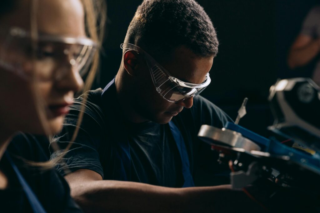 Individuals on the line of a glassware manufacturing plant.